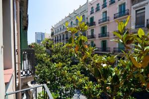 a balcony with trees and a building in the background at Nisia B&B in Barcelona