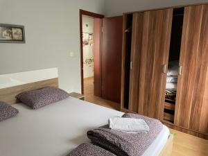 a bedroom with a bed with two pillows on it at Apartments Don in Belgrade