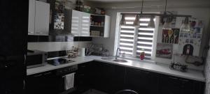 a kitchen with white counters and a window and a sink at kys home in Vulcan