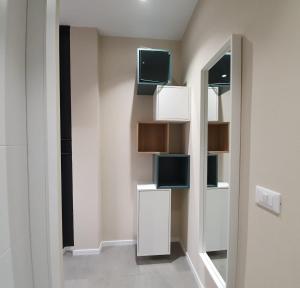 a room with a mirror and a tv on the wall at Residenza Azzurra in Cattolica +38 photos