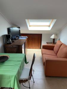 a living room with a couch and a table at Apartamentos Casa Ameiros in San Vicente de O Grove