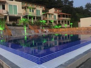 a swimming pool in front of a building at Green Hills Batumi in Batumi