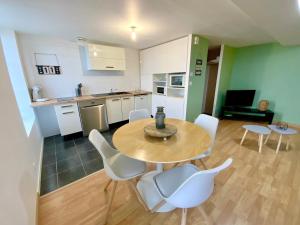 cocina y comedor con mesa y sillas en Gite LA VUE LOIRE Appartement, en Saint-Denis-de lʼHôtel