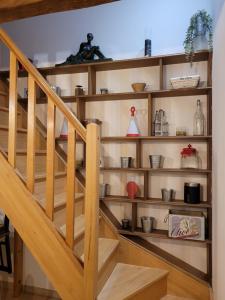 a staircase with wooden shelves in a room at Proche Chambord La petite maison in Thoury