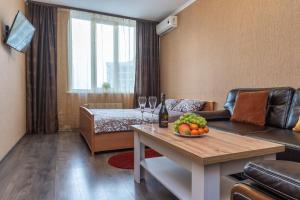 a living room with a couch and a table with fruit on it at Apartment with View on 24 floor in Kyiv