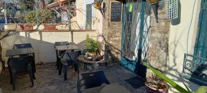 a patio with chairs and a table and a building at Auberge du Chêne in Maureillas