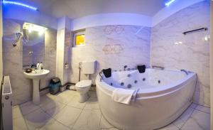 a bathroom with a tub and a toilet and a sink at Noblesse Deva in Deva +27 photos