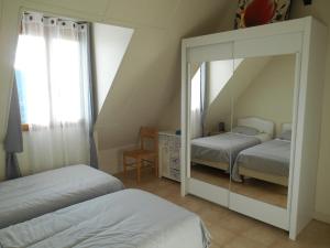 a bedroom with a mirror and two beds and a window at hortensia in Carlux