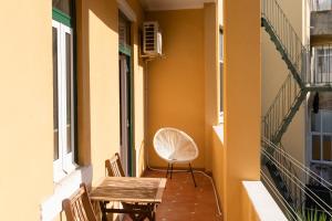a balcony with two chairs and a table at Your New Home in Lisbon - AC and Fast Wi-Fi in Lisbon
