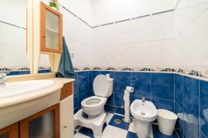 a blue and white bathroom with a toilet and a sink at Your New Home in Lisbon - AC and Fast Wi-Fi in Lisbon +23 photos