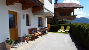 a patio of a house with chairs and a table at Haus Spitaler in Hippach