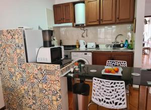 a kitchen with wooden cabinets and a black counter top at Scenic Comfort D in Ponta Delgada