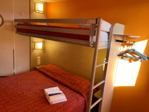 a bedroom with two bunk beds and a ladder at Premiere Classe Dunkerque Saint Pol Sur Mer in Saint-Pol-sur-Mer