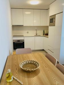 a kitchen with a wooden table with a bowl on it at Casa Sousa Alojamento A2 in Boticas +18 photos