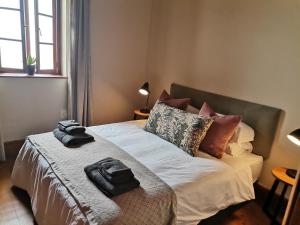 a bed with pillows and pillows on it at Point Village Hotel and Self Catering in Mossel Bay