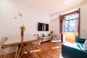 a living room with a table and a tv at Your New Home in Lisbon - AC and Fast Wi-Fi in Lisbon
