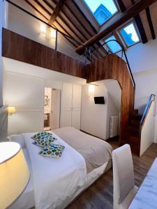 a bedroom with a large white bed in a room at B&B Palazzo Bruchi in Siena