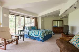 a bedroom with a bed and a large window at Bright, Unique Apartment in Heart of Wine Country in Newberg