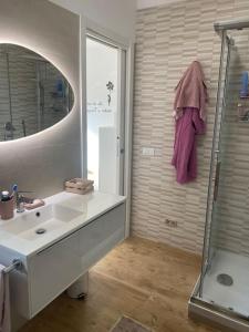 a bathroom with a sink and a shower and a mirror at Casa Molly appartamento Guidonia Tivoli terme in Guidonia