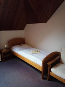 a bedroom with a bed with a book on it at Penzion Stella in Luhačovice