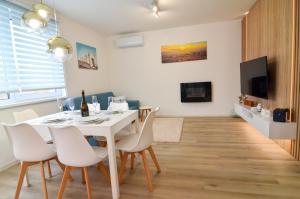 a dining room with a white table and chairs at Apartmán Astrid 4 in Mikulov