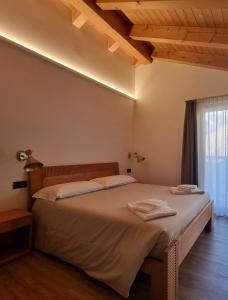 ein Schlafzimmer mit einem Bett mit zwei Handtüchern darauf in der Unterkunft Agriturismo Donec in Villa dʼAllegno