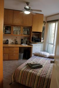 a bedroom with a bed and a kitchen at Dorraine's Jerusalem Bed & Breakfast in Jerusalem
