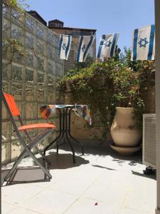 a table and a chair on a patio at Dorraine's Jerusalem Bed & Breakfast in Jerusalem