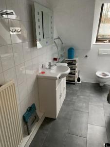 a bathroom with a sink and a toilet at Heart of Celle in Celle