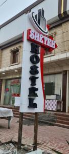 a sign for a restaurant in front of a building at Sheykh hostel in Andizhan
