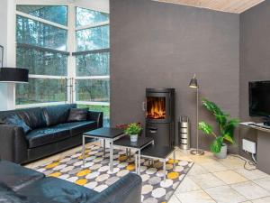 - un salon avec un canapé et une cheminée dans l'établissement 8 person holiday home in Ebeltoft, à Øksenmølle