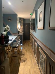 a dining room with a table and chairs and blue walls at Lyon City Home's Bed & Breakfast in Villeurbanne