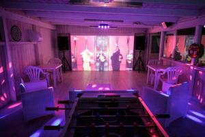a purple room with chairs and a stage with a person on the stage at Villa Acqua Dolce in Taurisano +43 photos