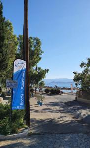 a blue sign on a pole next to a street at Vasilis Studios in Kiveri