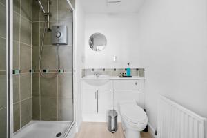 a bathroom with a shower and a toilet and a sink at Queens Apartments - Grampian Lettings Ltd in Aberdeen