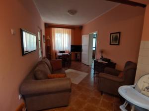 - un salon avec un canapé, des chaises et une table dans l'établissement Holiday home Neimarevic, à Risan