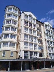 a large white building with windows on the side of it at Spacious apartment at the foot of Mashuk mountain in Pyatigorsk
