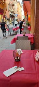a table with a red table cloth on top of a table at Hotel Roma in Bologna