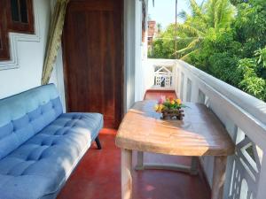 porche con banco y mesa en el balcón en location weligama, en Weligama