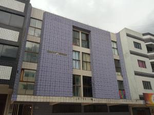 a building with a blue tile facade at kit Catavento in Brasilia