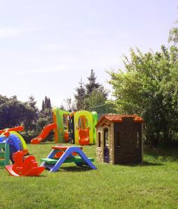 a group of childrens play equipment in the grass at Promyki - Domki Apartamentowe in Chłopy