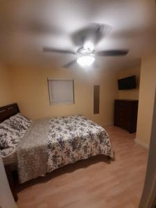 a bedroom with a bed and a ceiling fan at Smalls Cozy Rest with dock in Alice Town