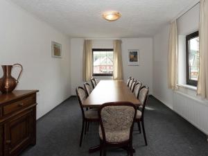 a dining room with a table and chairs at Spacious holiday home in the Ore Mountains in Deutschneudorf