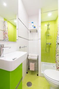 a green and white bathroom with a sink and a toilet at Apartamento Vicky Victoria in Málaga +22 photos