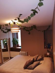 a bedroom with a tree branch hanging from the ceiling at "Les Chaillottes" in Chailles