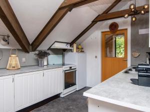 een keuken met witte kasten en een houten deur bij 6 person holiday home in Ebeltoft in Ebeltoft