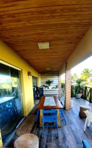 a wooden table and chairs on a patio at Villa das Águas - Térreo frente lago in Estância