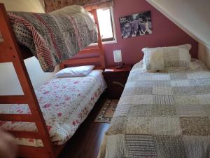 a bedroom with two beds and a bunk bed at Hospedaje Austral in Puerto Montt