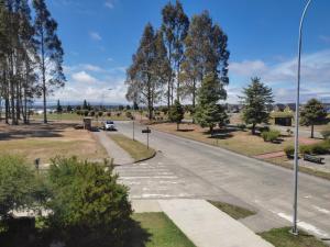 an empty road in a park with trees at Hospedaje Austral in Puerto Montt