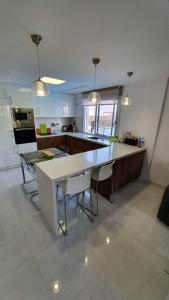 a kitchen with a large white table and chairs at Villa Luxury - Private Pool - Wifi - Solarium in Alicante